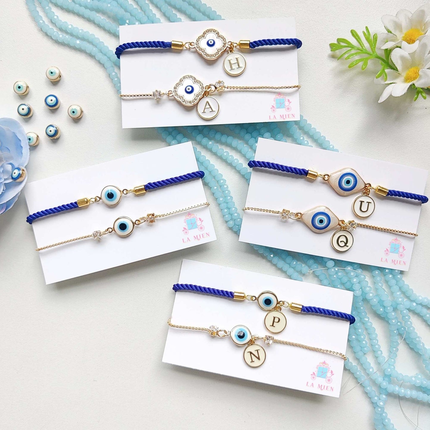 All three designs of the Personalized Bhaiya Bhabhi Evil Eye Rakhi Bracelet Set – featuring evil eye charms, custom initial tags, blue cord for Bhaiya / brother, and golden chains for Bhabhi / sister /sister-in-law