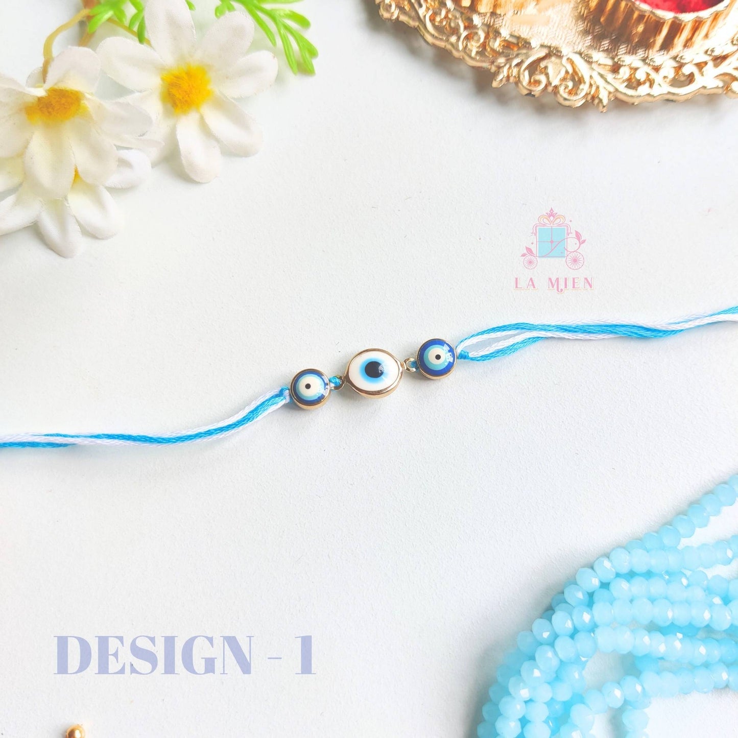 design 1 of evil eye rakhi with blue thread