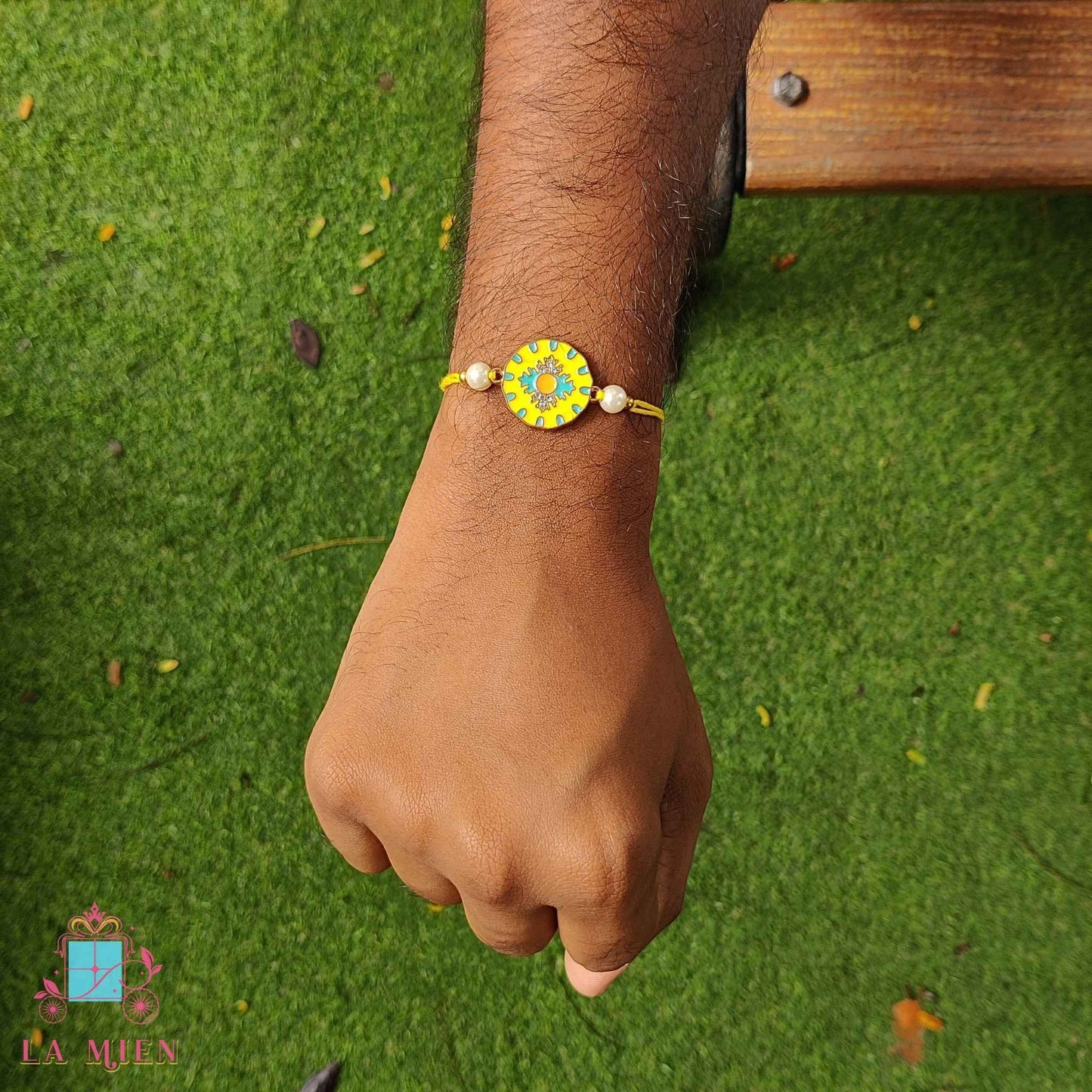 yellow designer rakhi hand shot