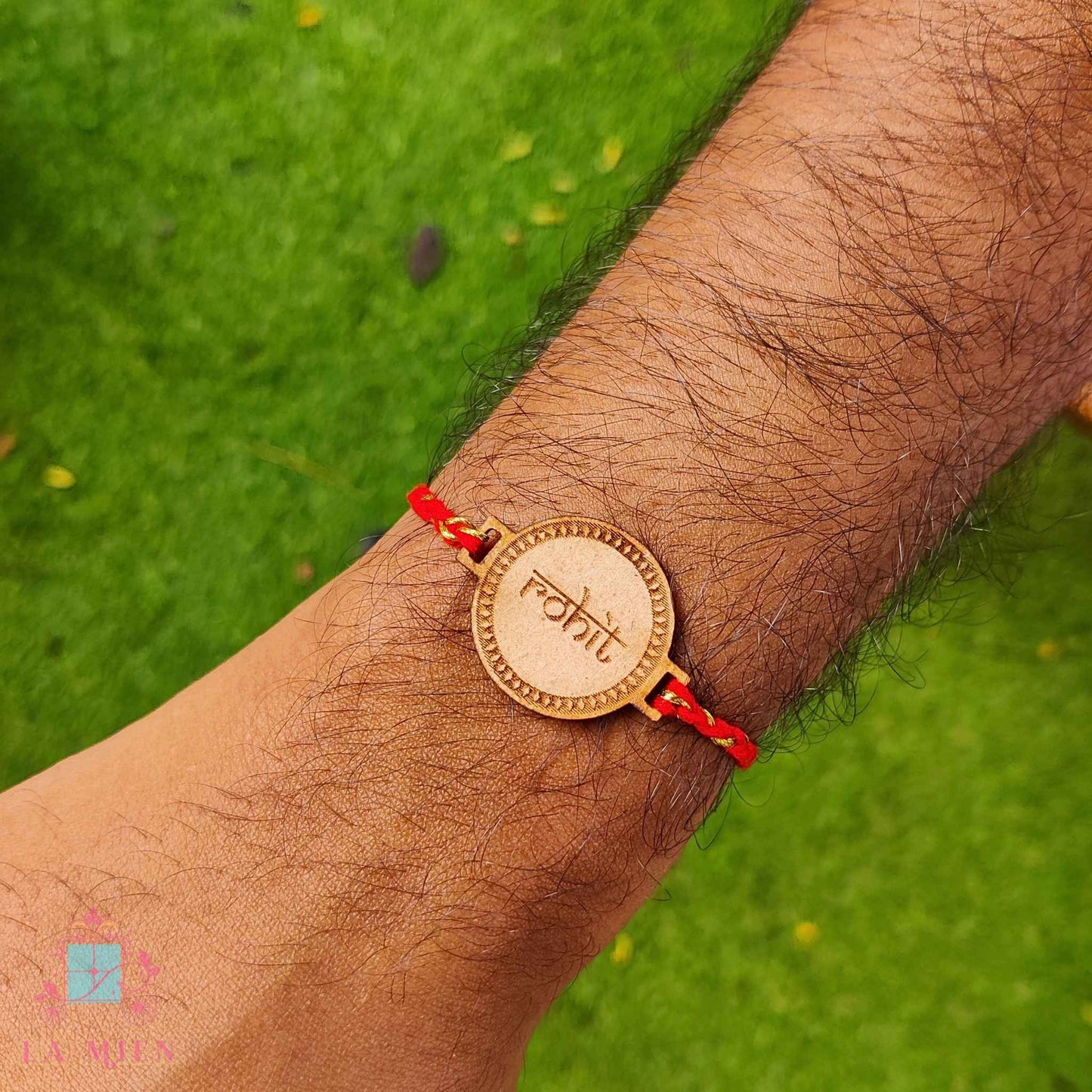 handshot of wooden MDF rakhi with custom name in indian calligraphy