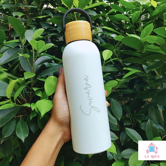 customized white insulated metal bottle with smooth silicone exterior and bamboo carry cap.