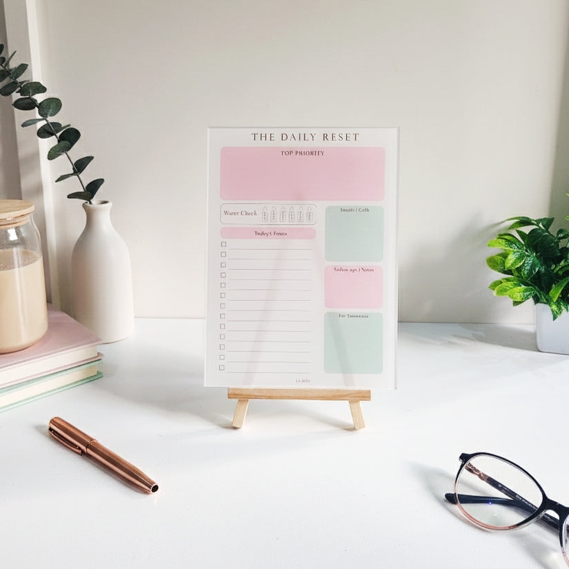 Reusable acrylic daily planner with a minimal clutter-free layout for productivity, displayed on a soft aesthetic desk setup.